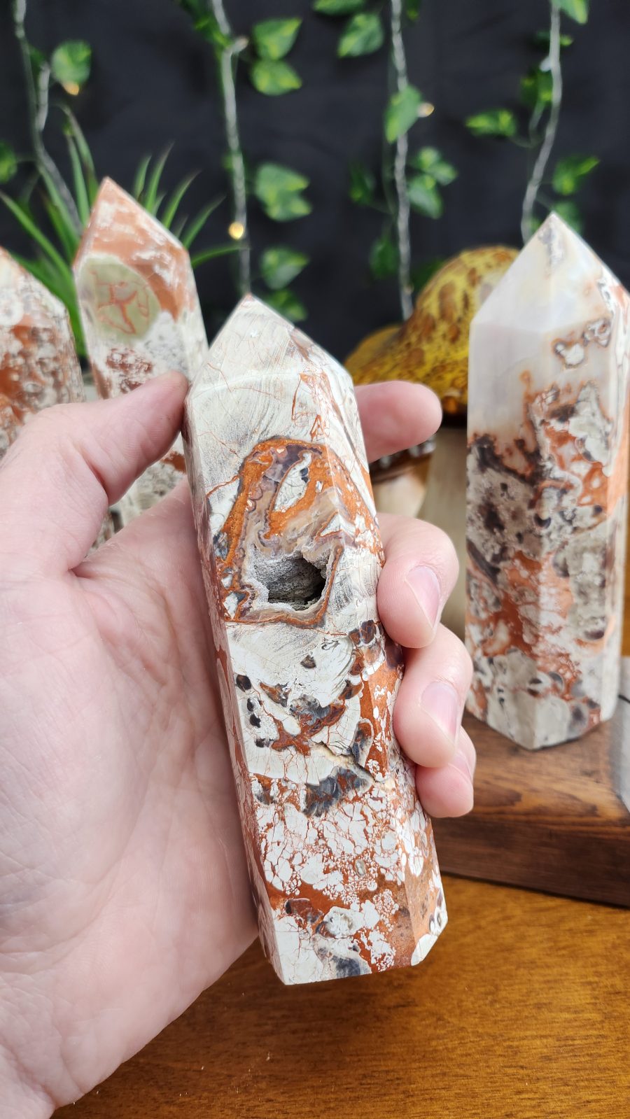 Money Agate Large Crystal Towers shown in hand for scale.