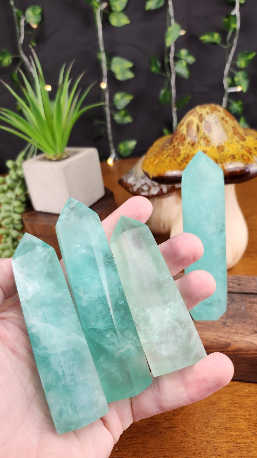 Mint Green Fluorite crystal towers shown in hand for scale.