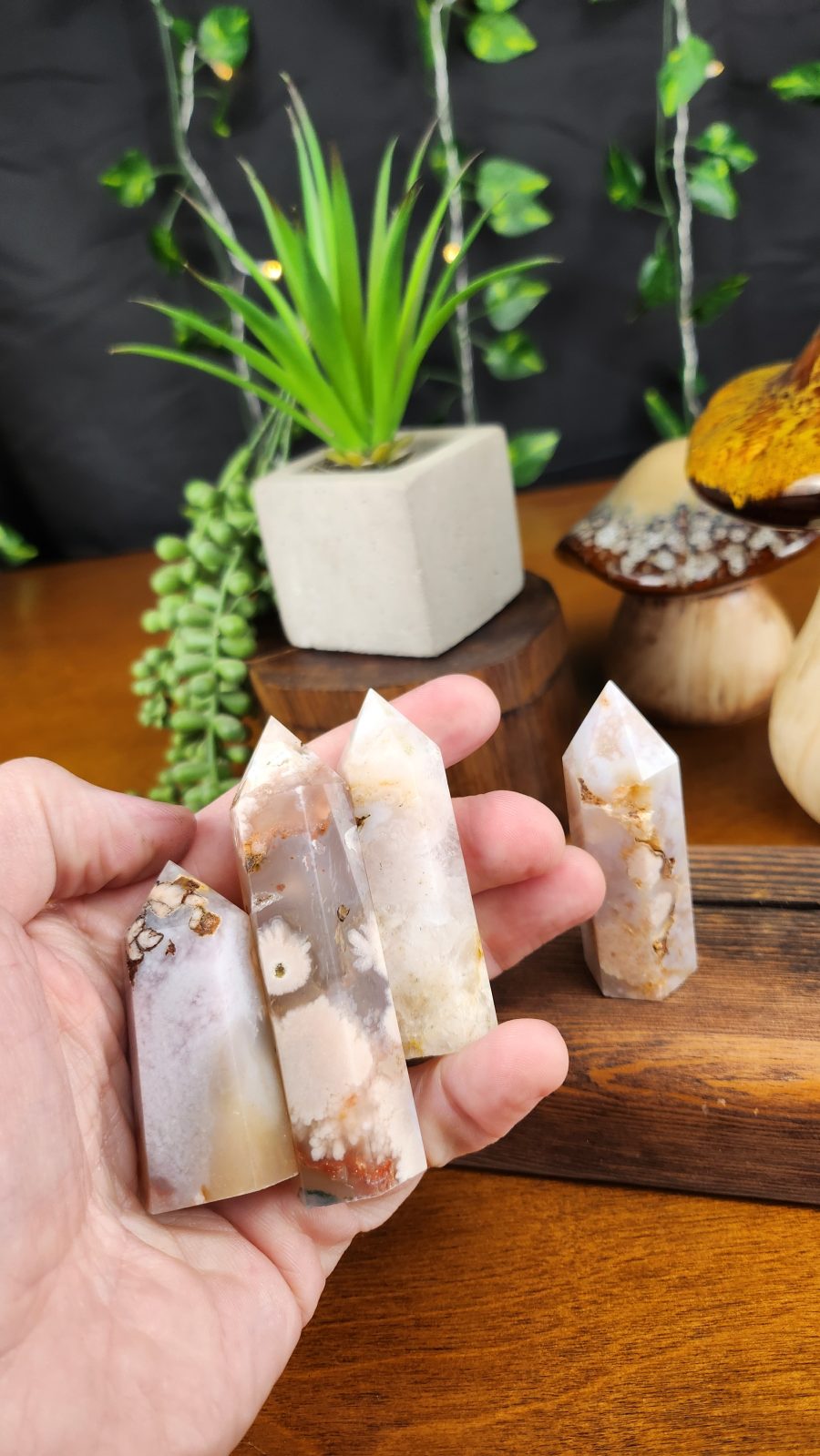 Flower Agate Crystal Points shown in hand for scale.