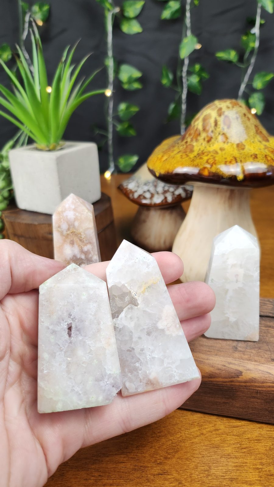 Pink Amethyst with Flower Agate Crystal Towers shown in hand for scale.